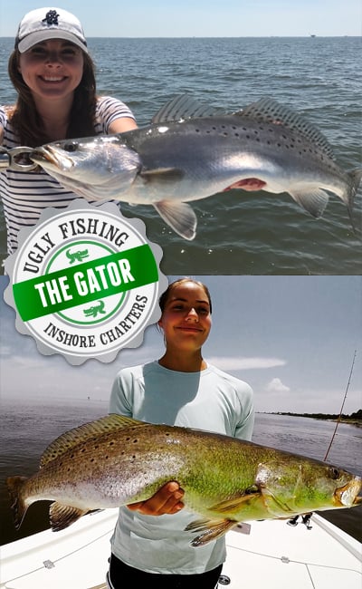 two ladies holding very large speckled trout