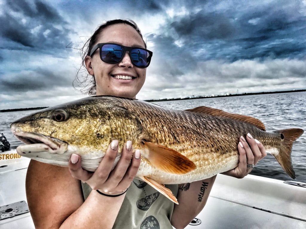 young-lady-holding-large-redfish